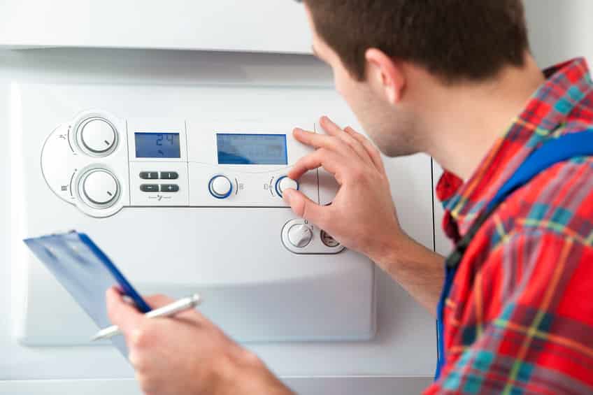 technician servicing heating boiler
