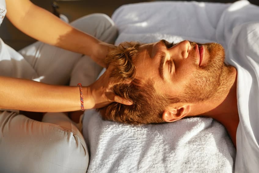 spa massage. man enjoying relaxing head massage outdoors. beauty