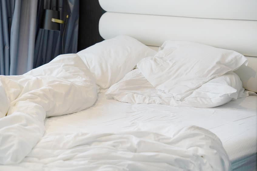 dirty bed in the hotel. dirty bed pillow blanket room.